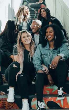 3 women sitting on red carpet